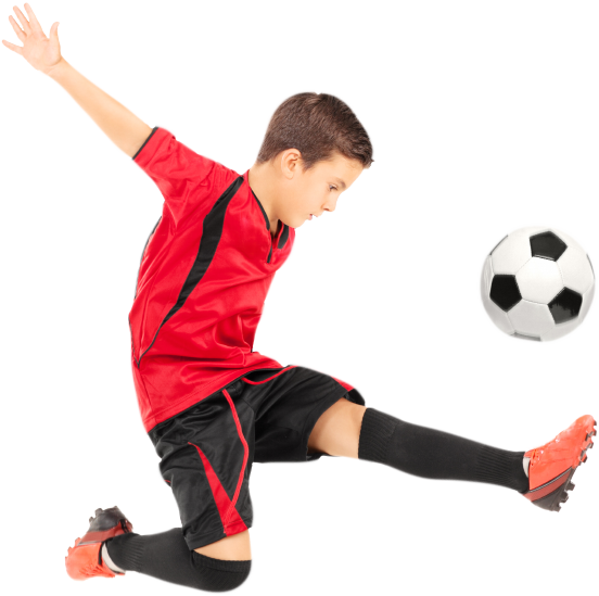 Boy kicking soccer ball